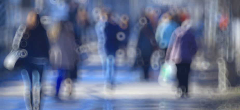 blurred image of a group of people walking in the street