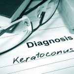 reading classes sitting on a doctors pad with a diagnosis of keratoconus