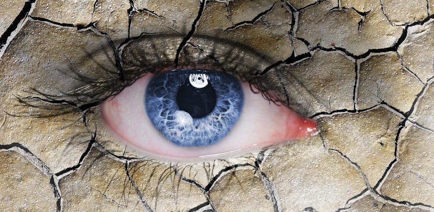 concept illustration of a dry, red eye made to look like a dry, cracked desert landscape