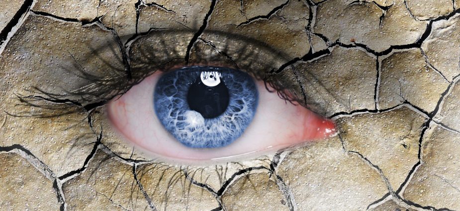 concept illustration of a dry, red eye made to look like a dry, cracked desert landscape