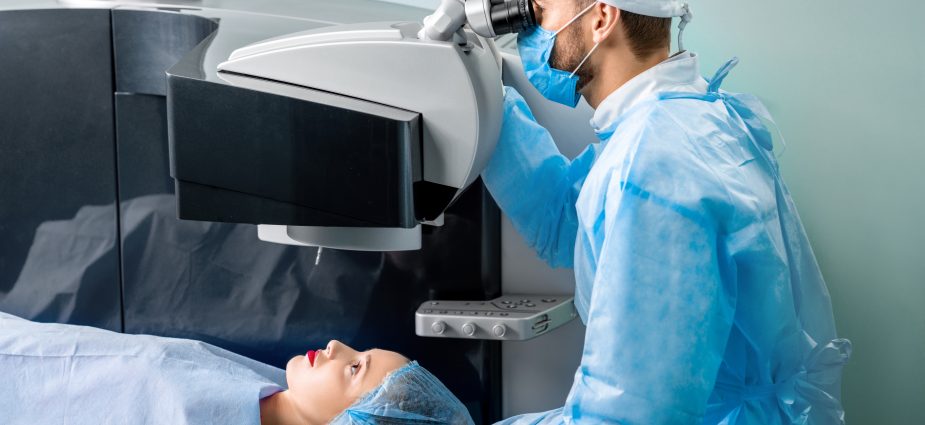 eye doctor performing laser eye surgery on a female patient