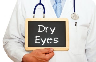 concept image of a doctor in a white lab coat holding a chalkboard with dry eye written on it