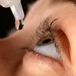 close up view of eye drop application in the left eye