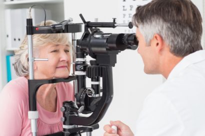 older female eye surgery patient undergoing a comprehensive exam