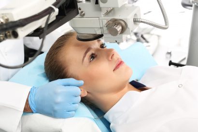 female vision surgery patient having her eye examined by her surgeon as part of treatment