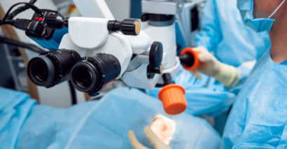 team of doctors performing cataract surgery on a patient's left eye