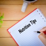 a person documenting nutrition tips in a notepad